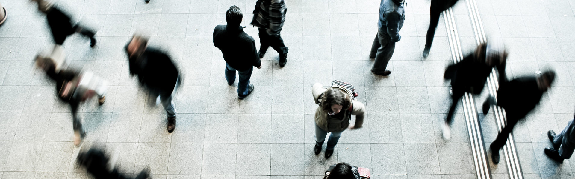 Overhead view of people walking and talking in a public space